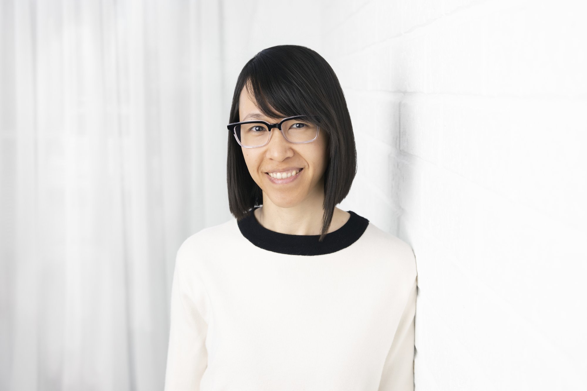 Farah Gulamoydeen, psychologist at Forepsych, smiling in a bright studio setting